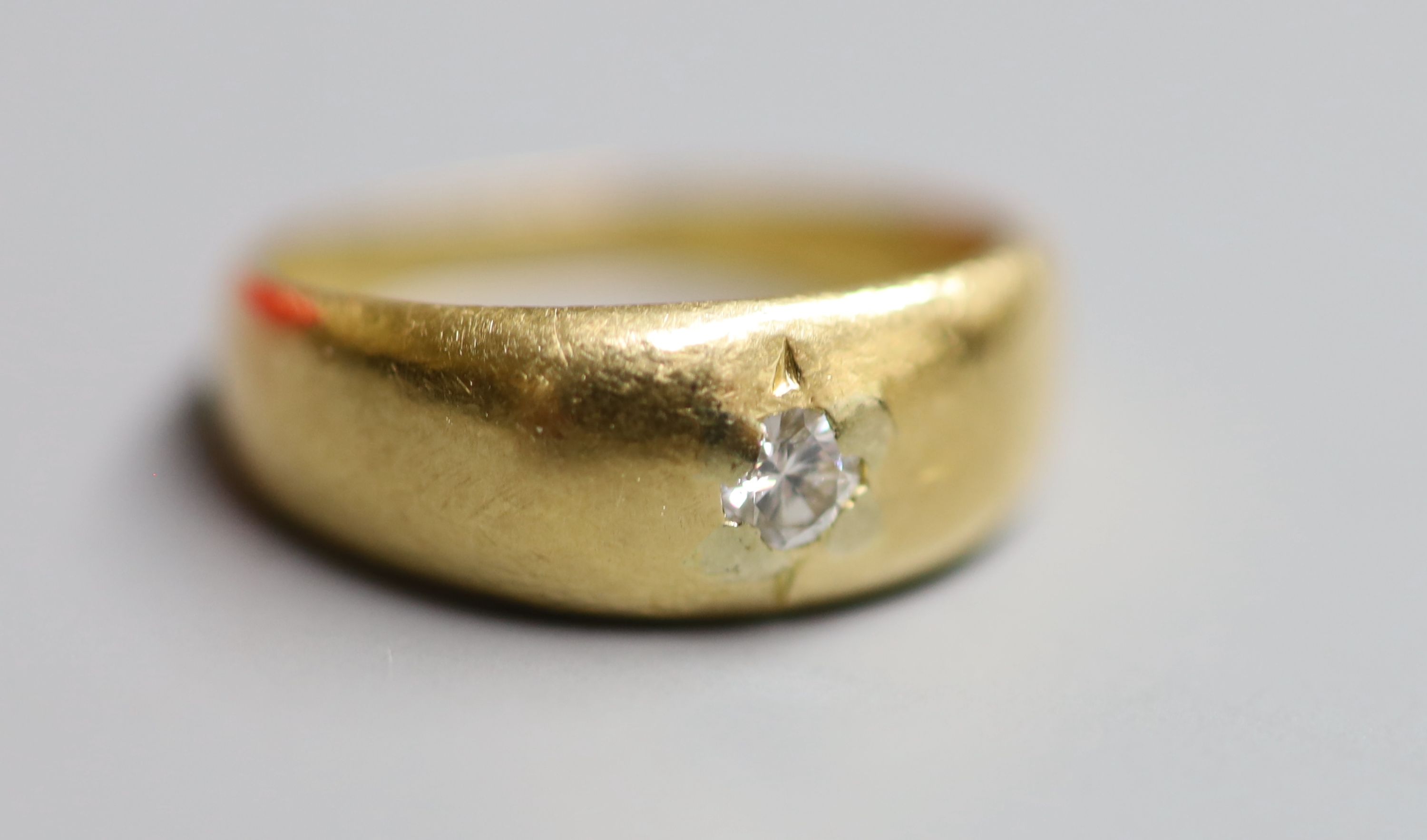 An early 20th century 18ct gold and gypsy set solitaire diamond ring, size J, gross 4.4 grams.